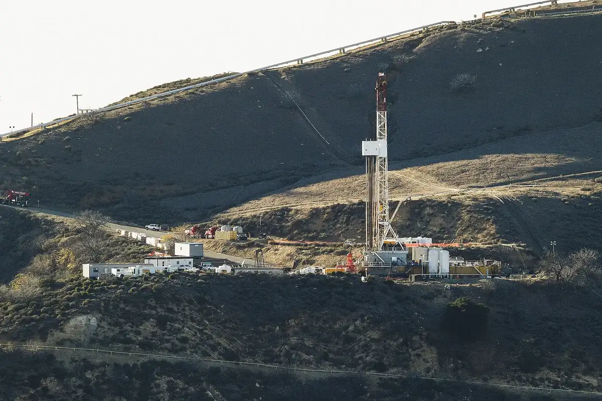 Drilling rig, trailers and equipment on a brushy ridge at the Aliso Canyon natural gas storage facility above Porter Ranch