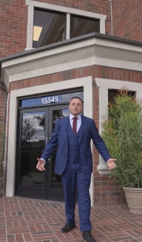 David Petikyan in a blue suit outside his office building at 15545 Devonshire St in Mission Hills