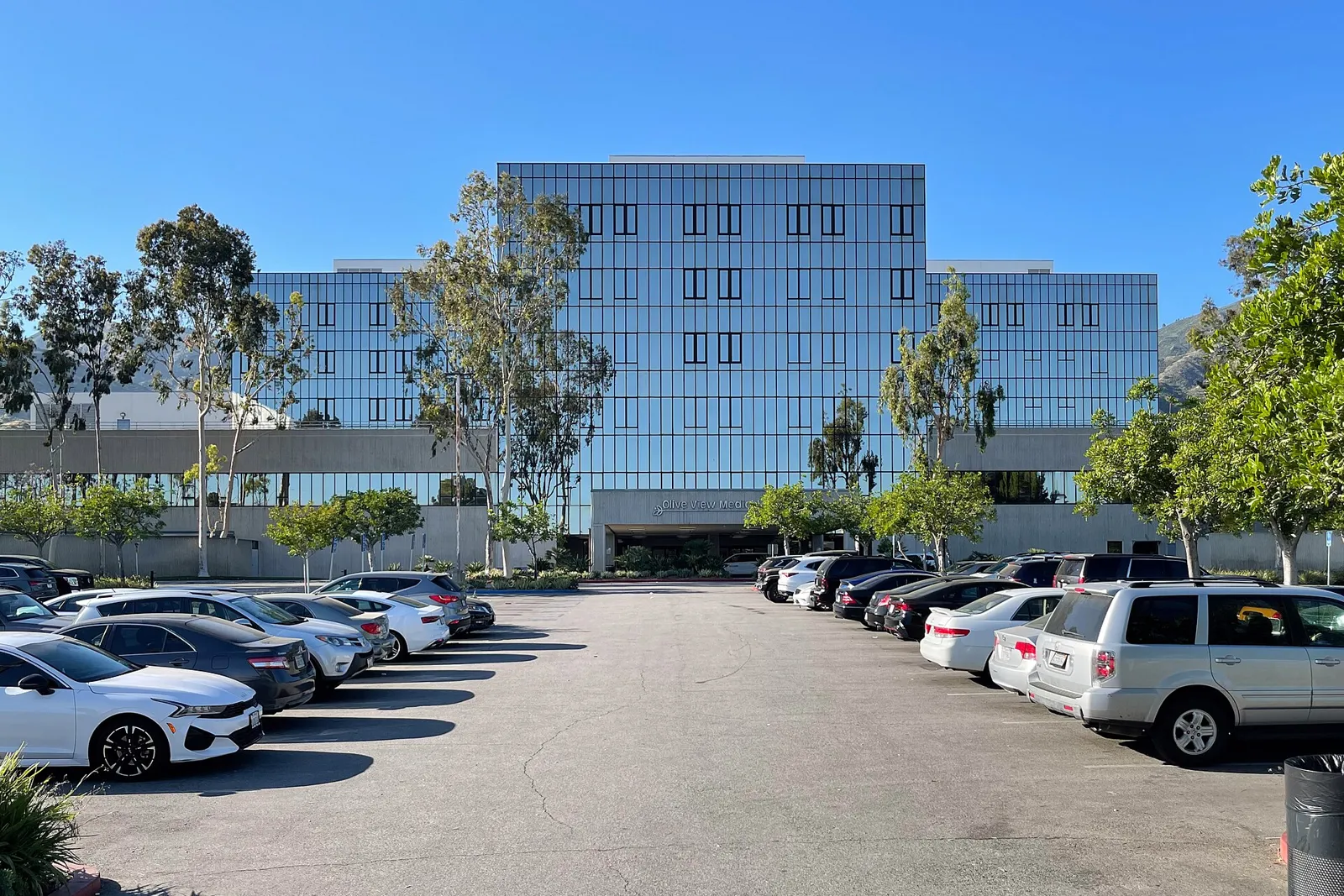Olive View-UCLA Medical Center building and parking lot in Sylmar under a blue sky