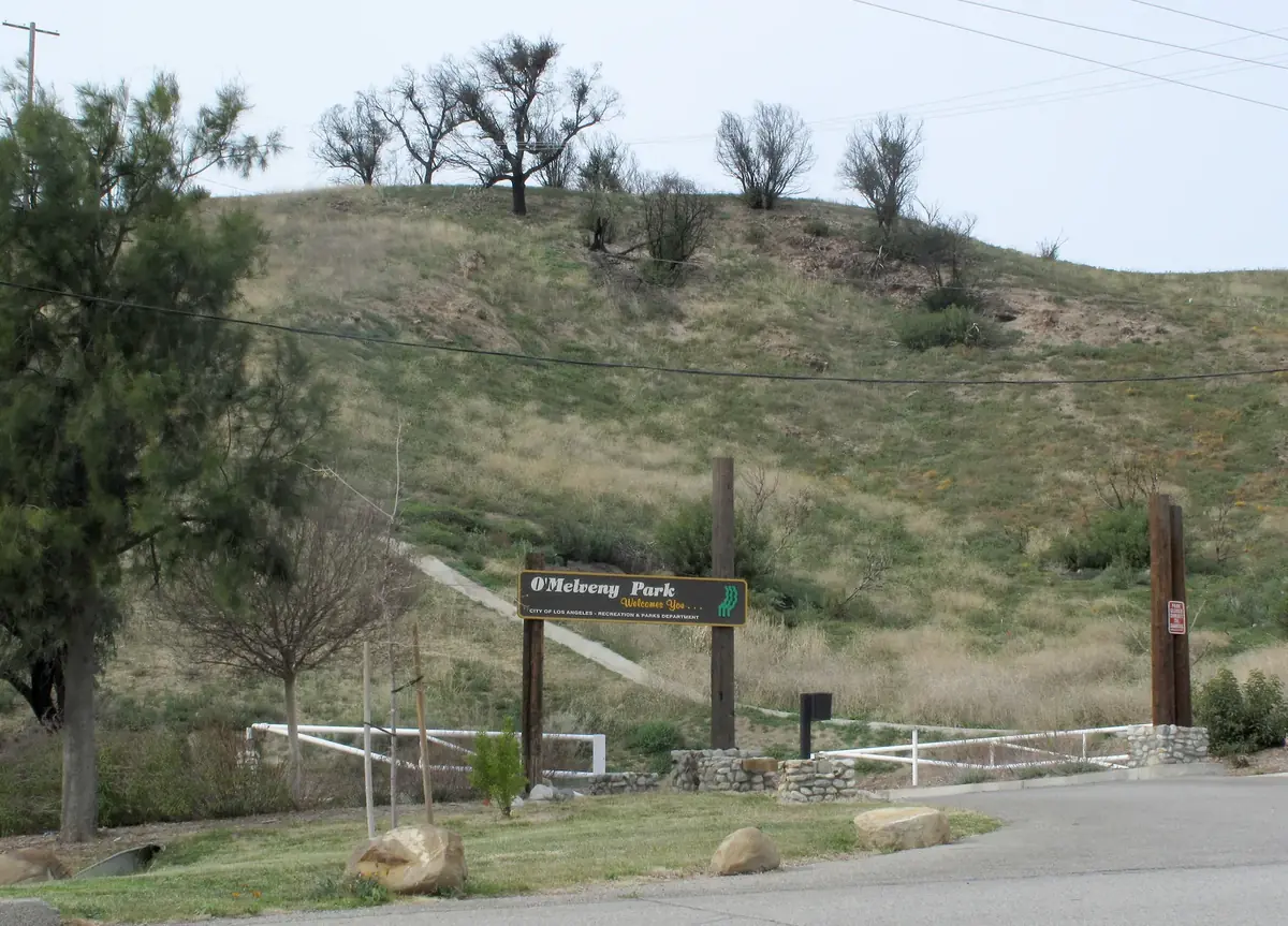 Entrance sign at O'Melveny Park on a grassy hillside in Granada Hills, Los Angeles