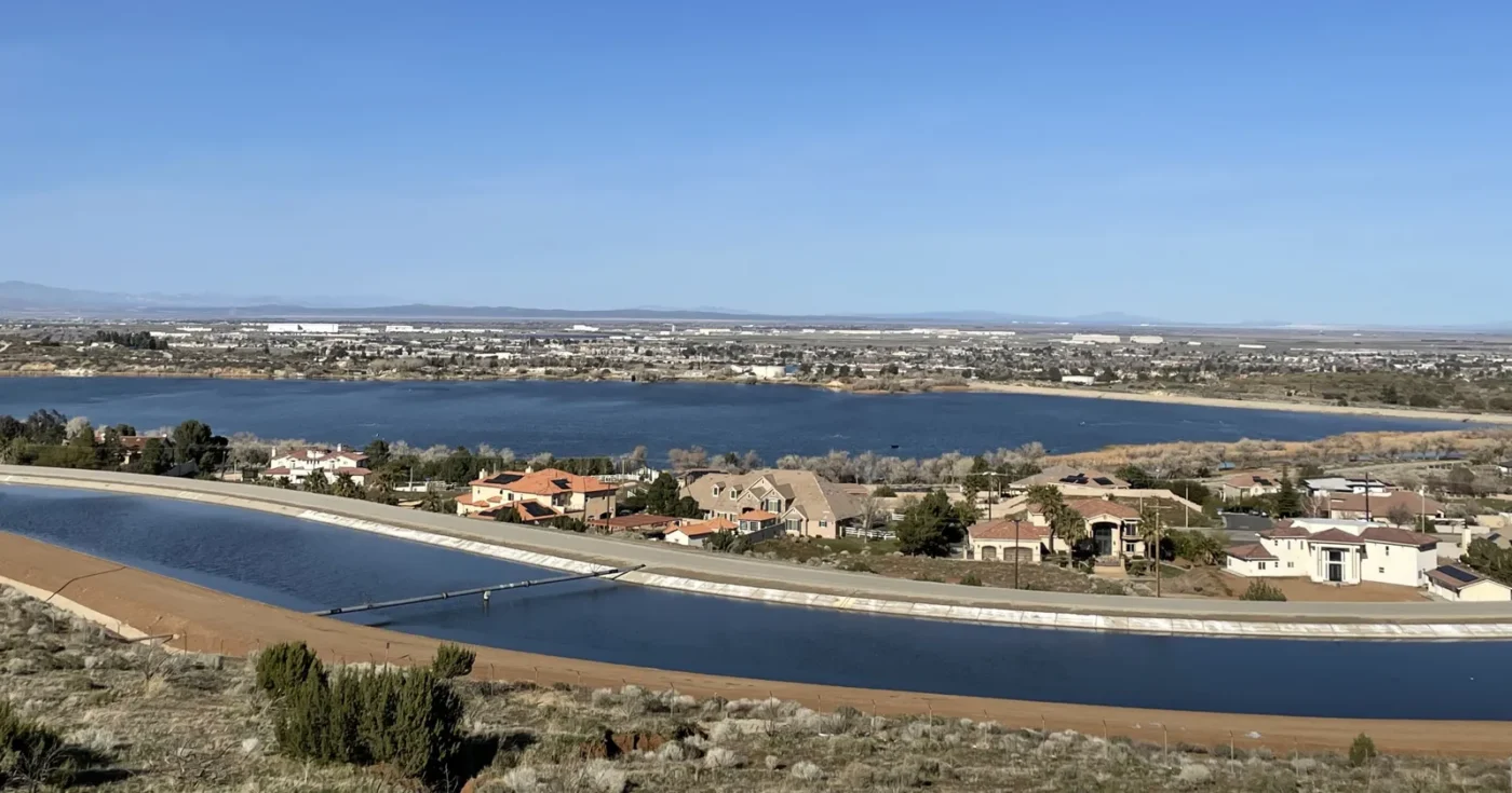 Homes along the California Aqueduct above Lake Palmdale, with the city and Antelope Valley stretching to the mountains