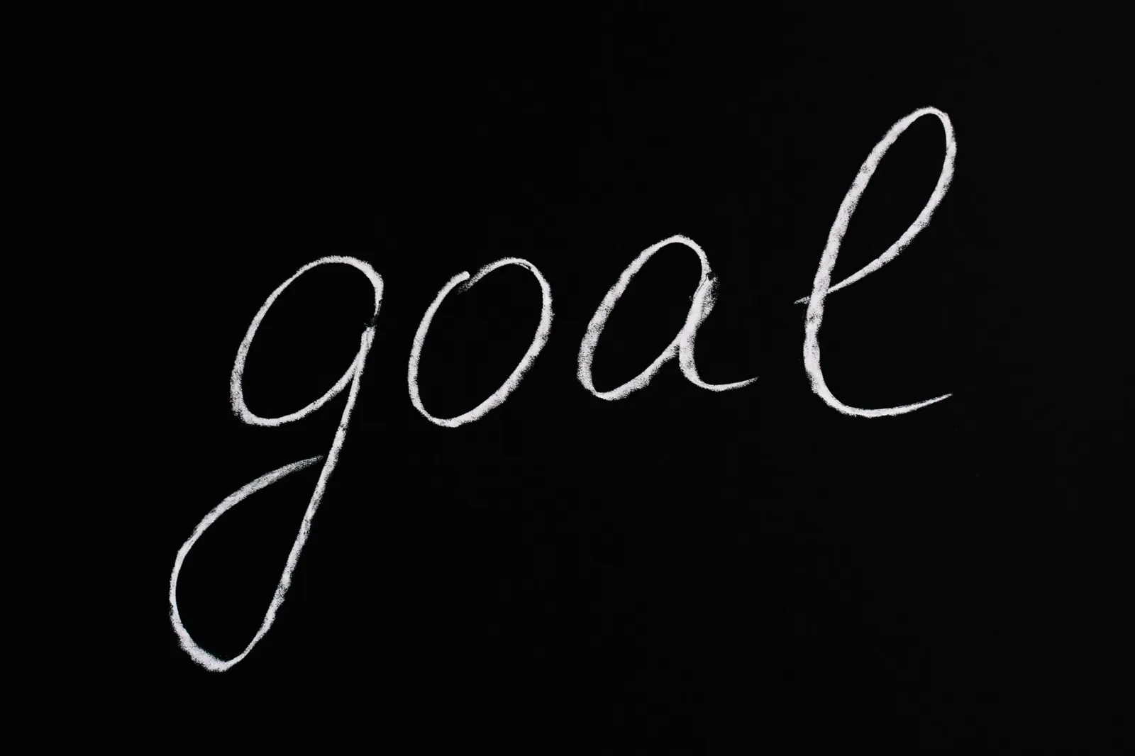 The word 'goal' written in chalk on a blackboard