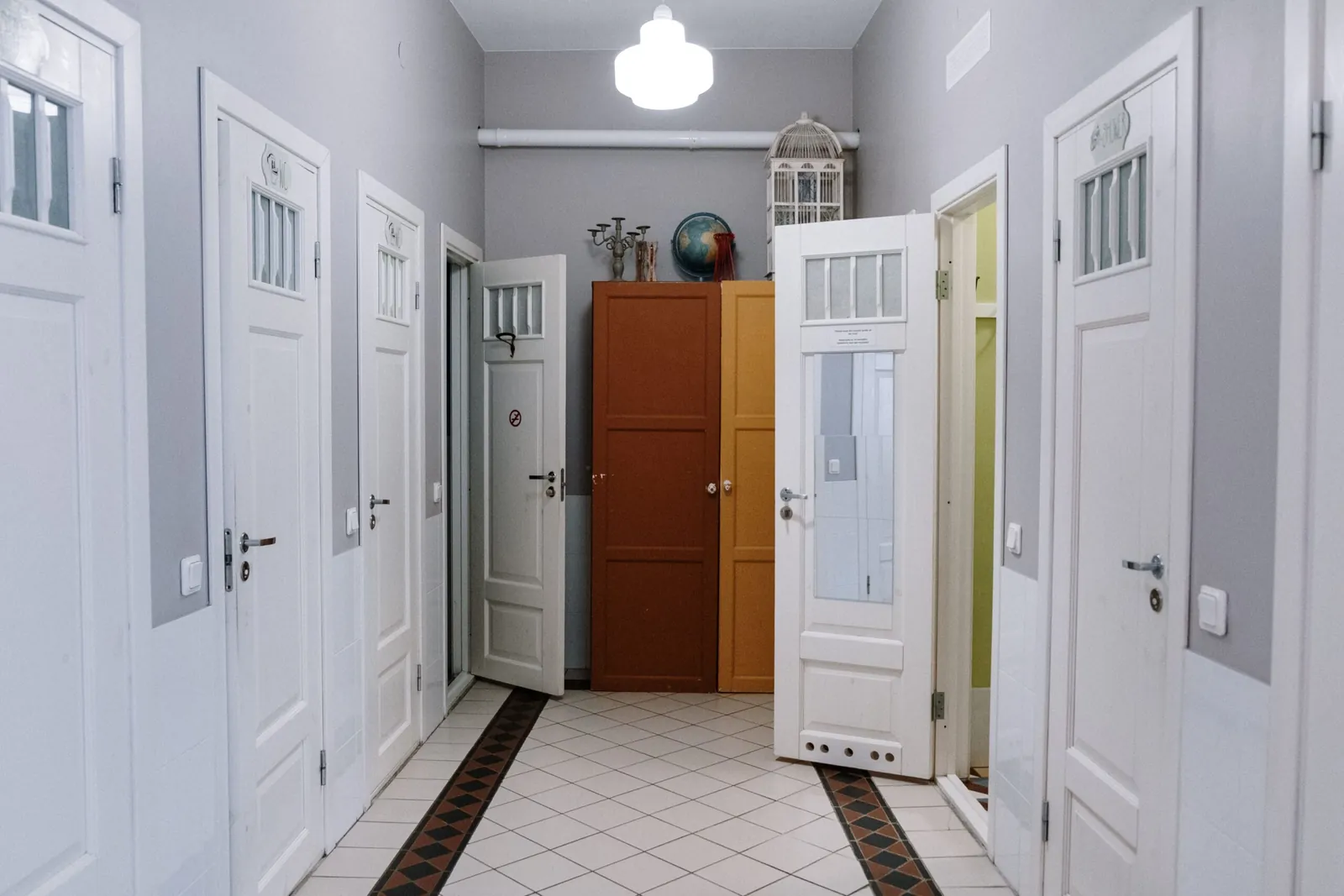 Bright hallway with white doors inside a home
