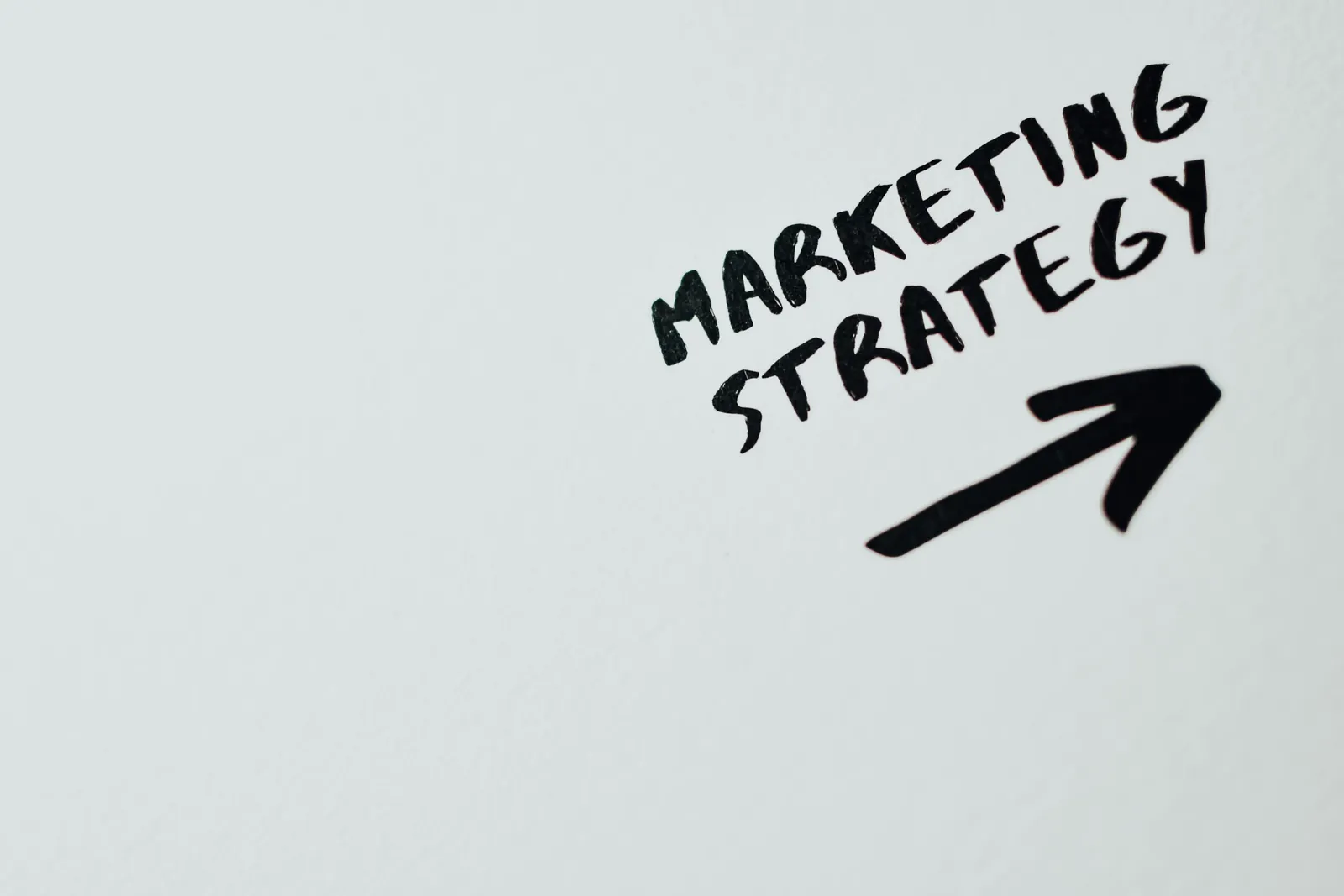 Paper with the words Marketing Strategy and an arrow