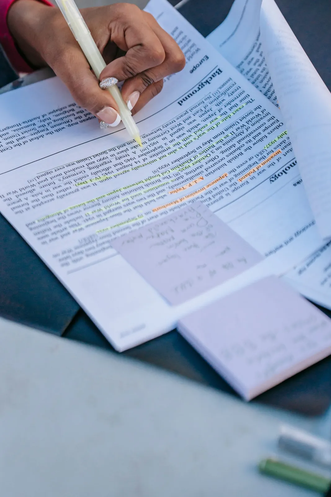 Person reviewing and highlighting a printed agreement