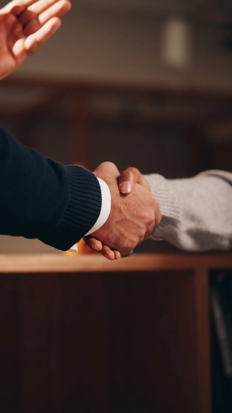 Business handshake across a desk