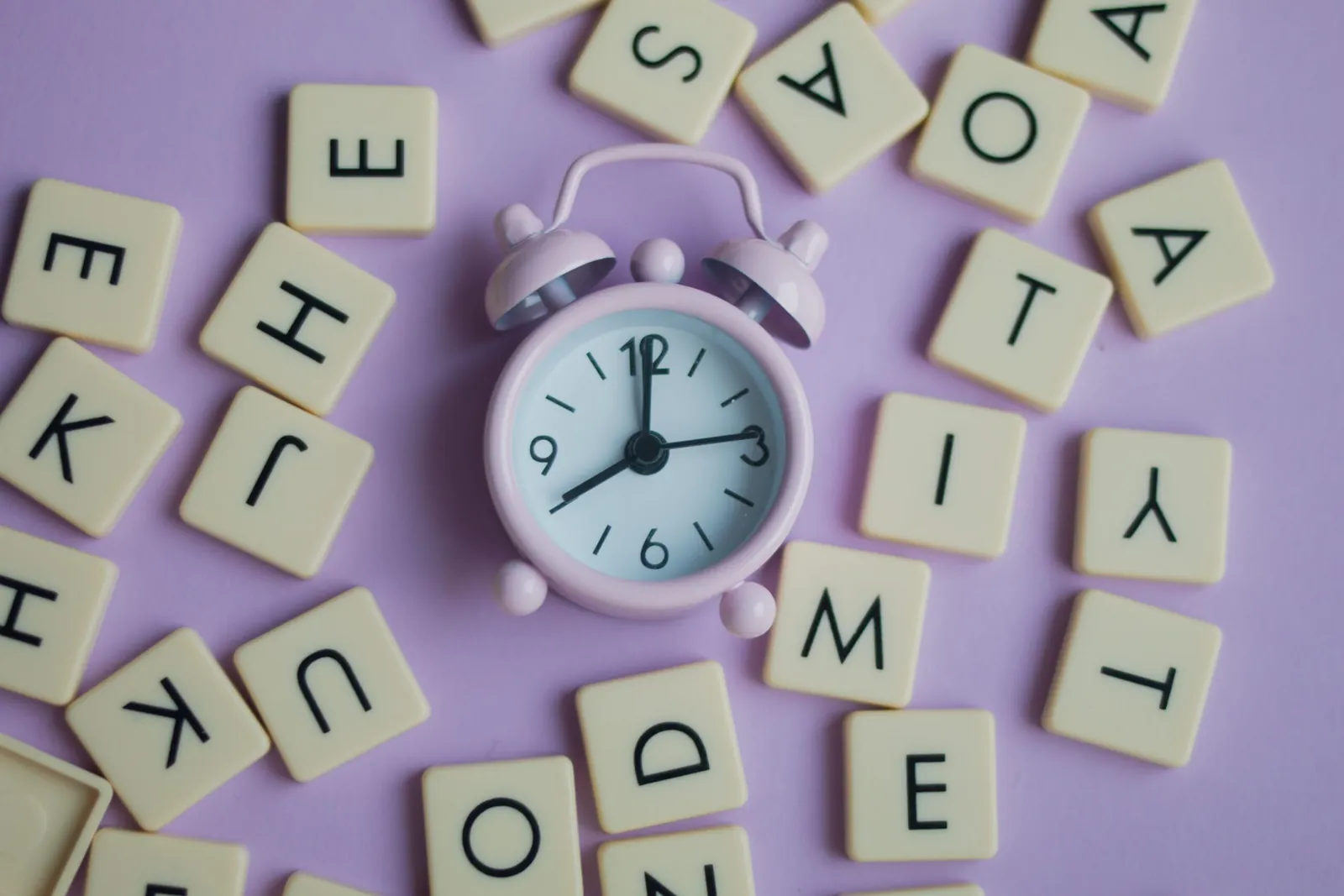 Alarm clock surrounded by letter tiles