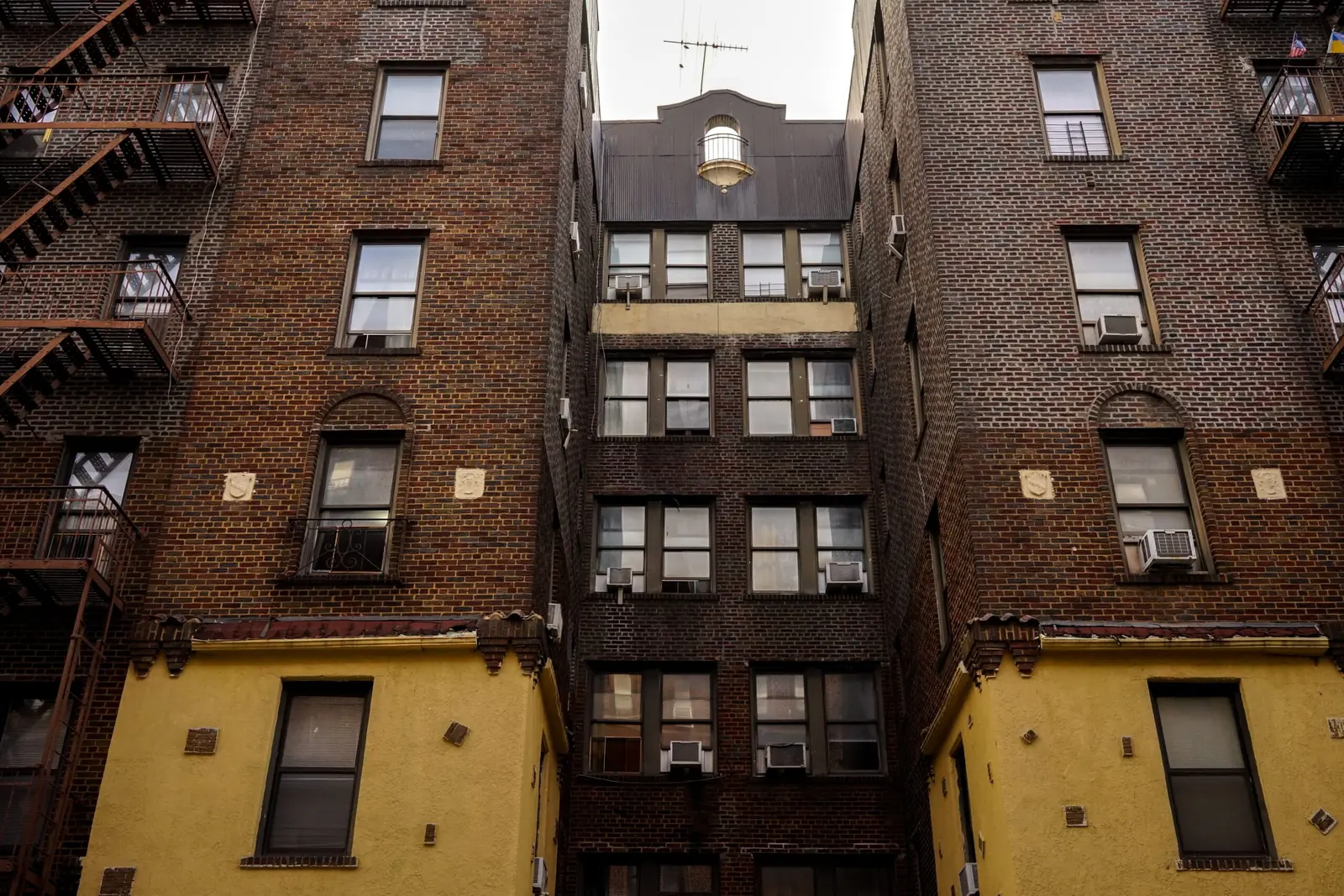 Brick apartment buildings with fire escapes