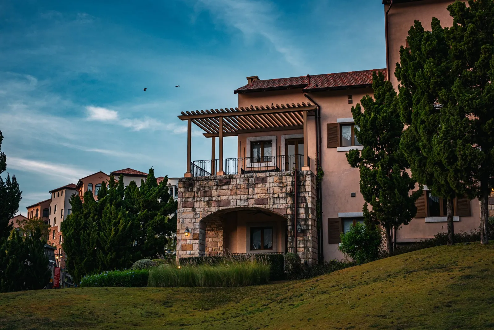 Mediterranean-style two-story home with a balcony