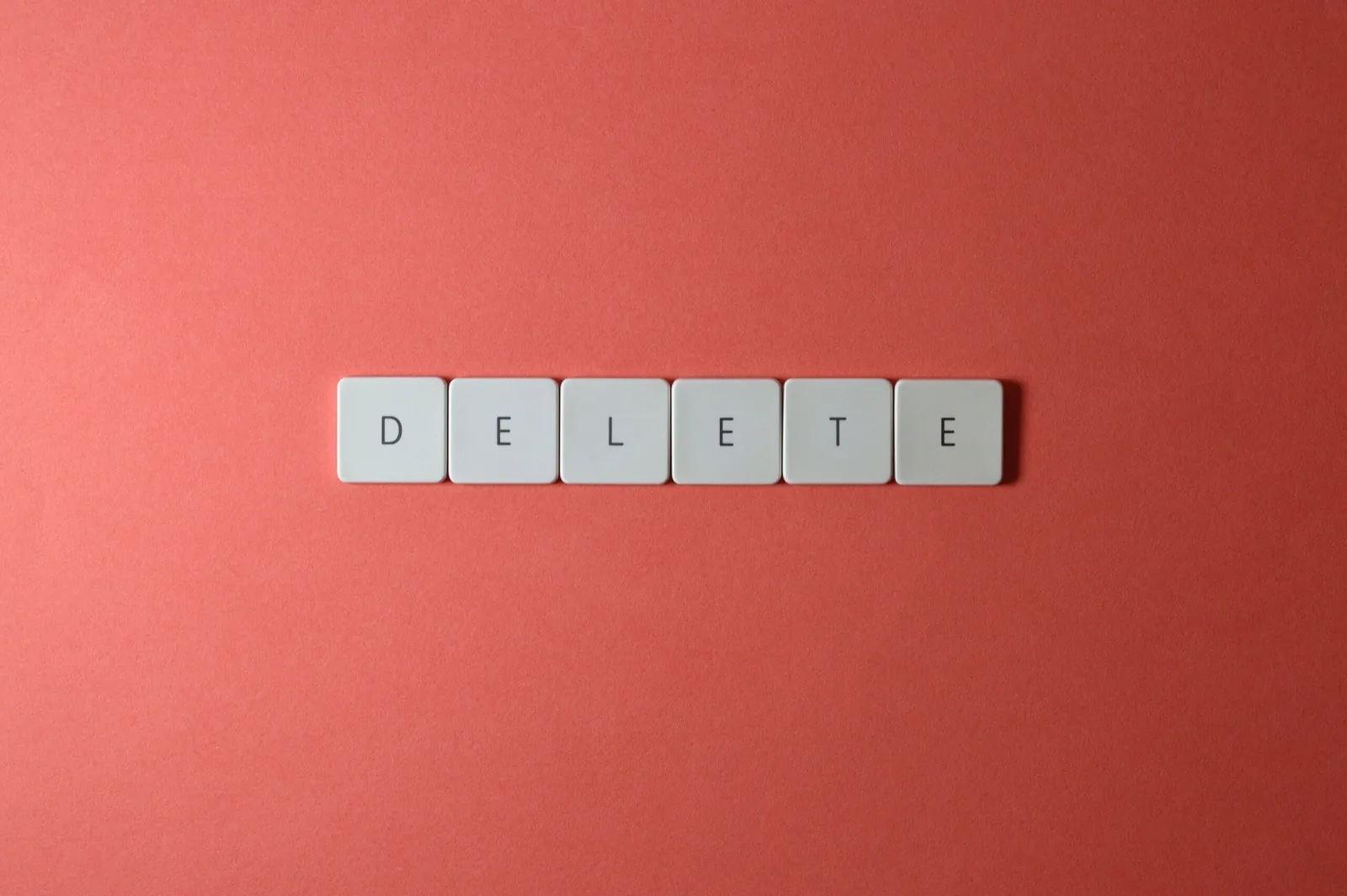 Letter tiles spelling 'DELETE' on a red background