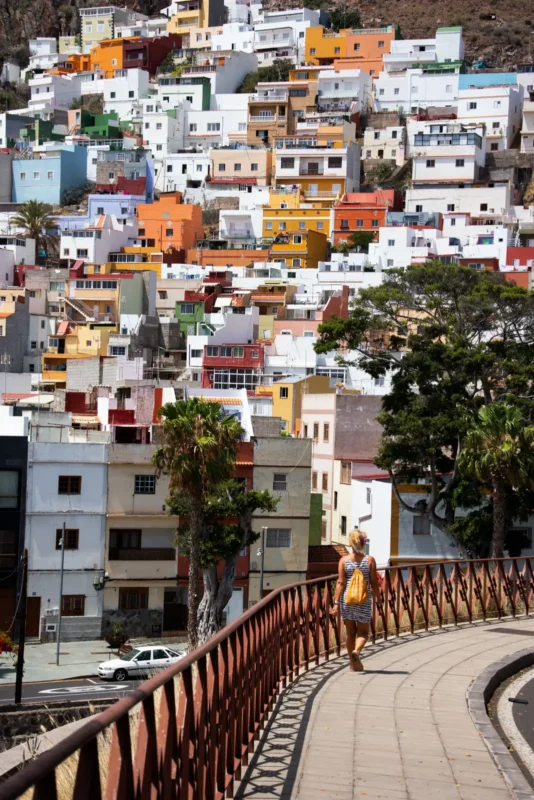 Colorful hillside houses above a curved walkway