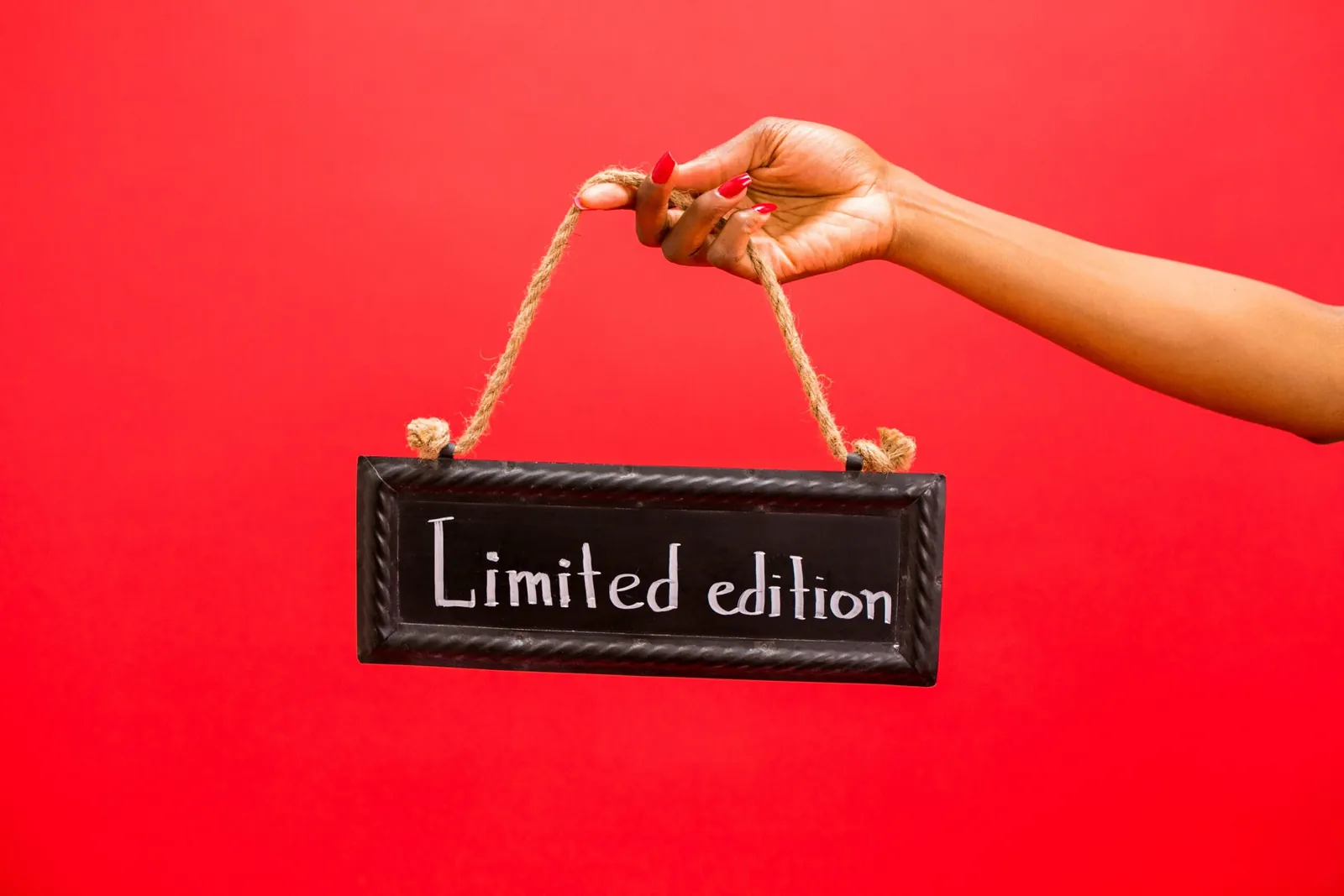 Hand holding a sign reading Limited edition
