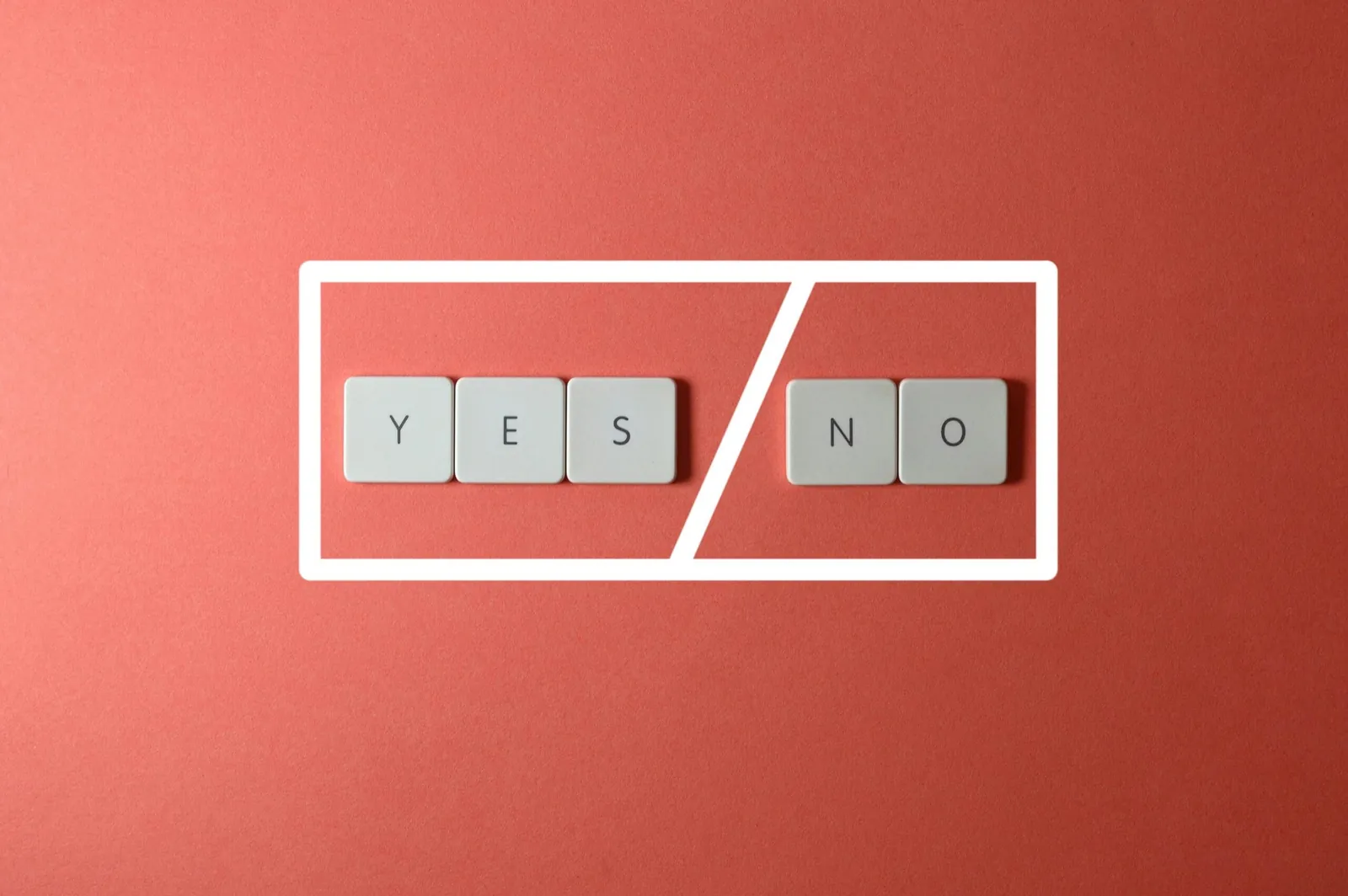 Letter tiles reading 'YES' and 'NO' on a red background
