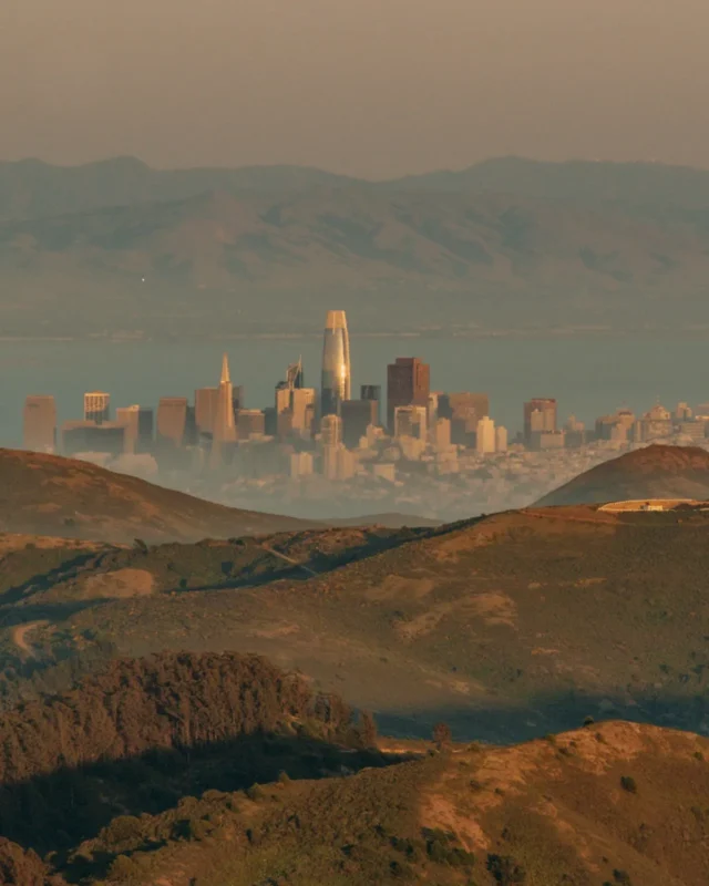 Distant city skyline beyond hazy brown hills