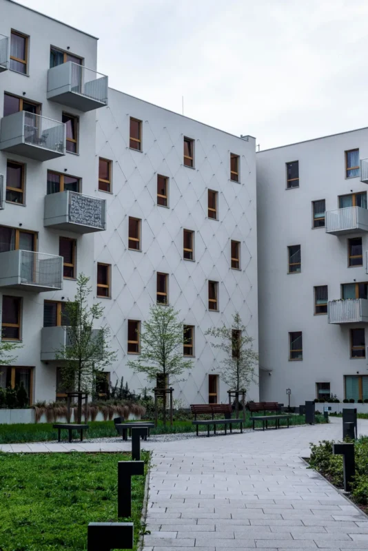 White modern apartment buildings around a landscaped courtyard