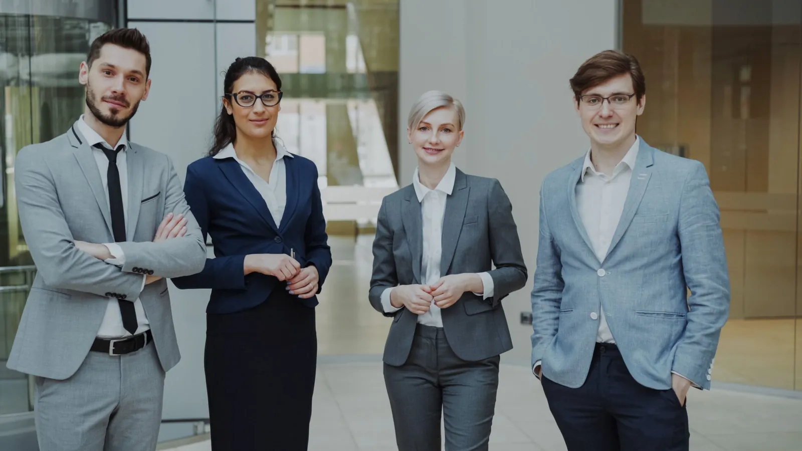Team of four real estate professionals in business attire