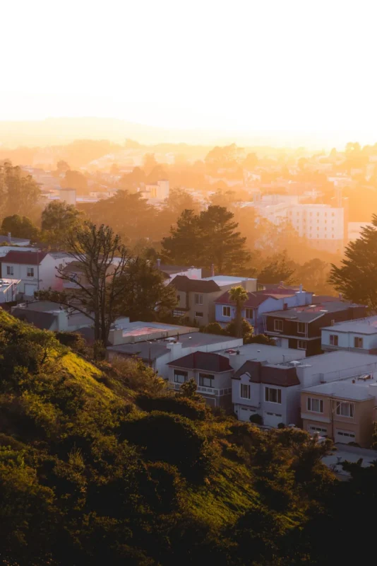 Hillside homes in golden sunset light