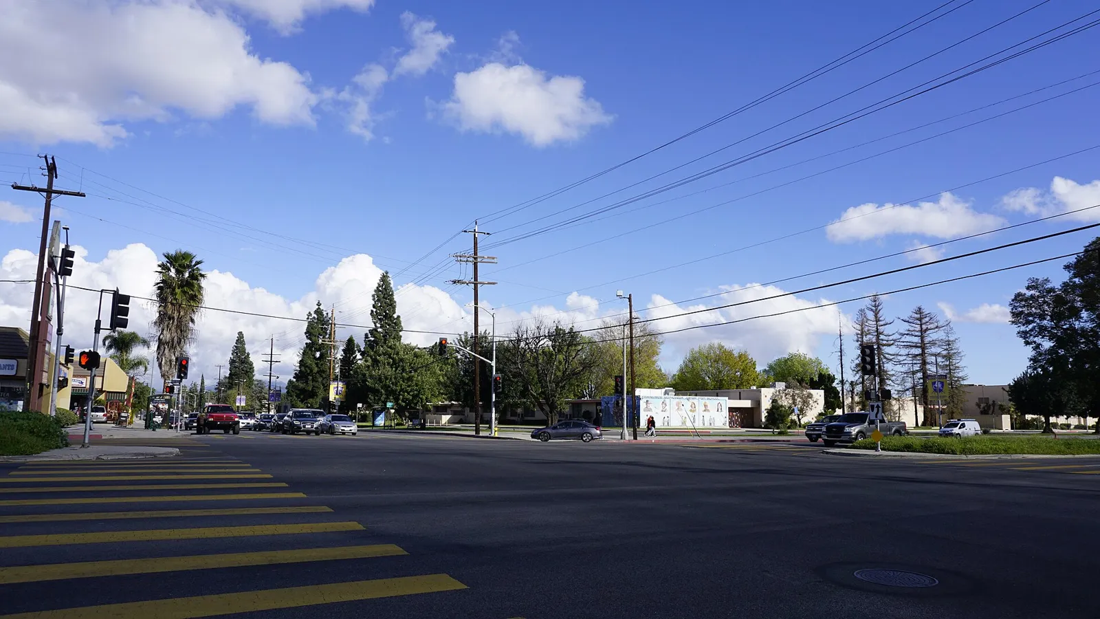 Intersection of Sepulveda Boulevard and Plummer Street in North Hills, Los Angeles, under a blue sky with palm trees