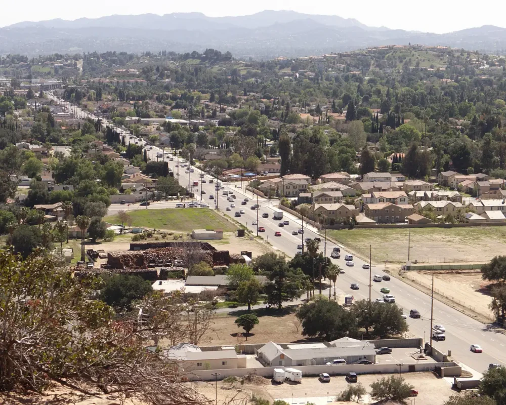 View from Stoney Point down Topanga Canyon Boulevard in Chatsworth, with homes and trees spreading toward the mountains